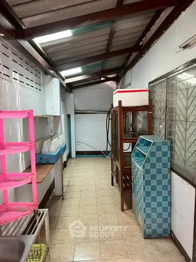 Narrow storage area with tiled floor and shelving, ideal for organizing household items.