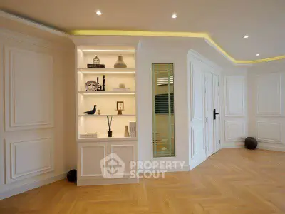 Elegant living room with built-in shelves and modern lighting