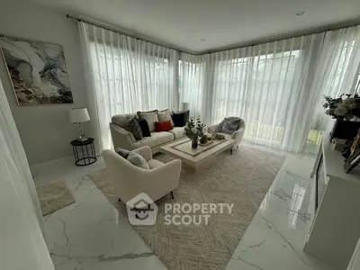 Elegant living room with modern decor and large windows for natural light