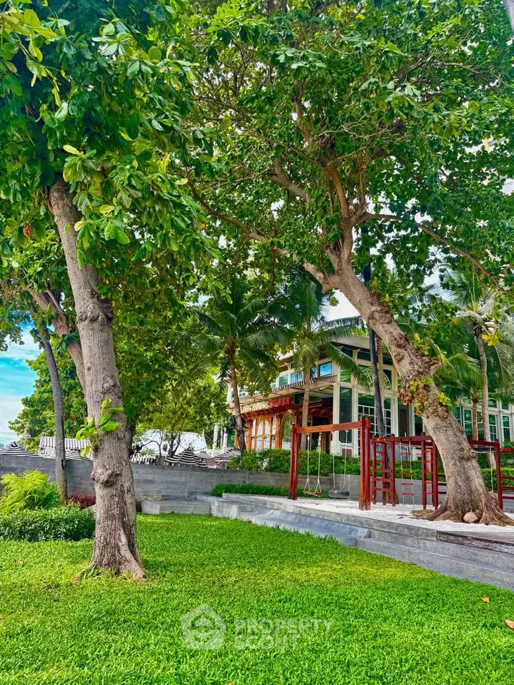 Luxurious beachfront property with lush garden and stunning ocean views.