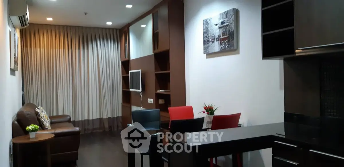 Modern living room with stylish furniture and open kitchen layout
