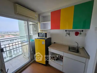 Compact kitchen with vibrant decor and balcony view