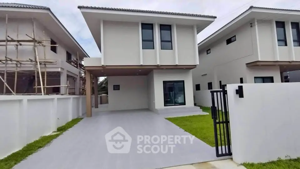 Modern two-story house with spacious driveway and minimalist design