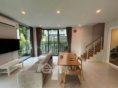 Modern living room with sleek furniture and garden view, perfect for relaxation and entertaining.