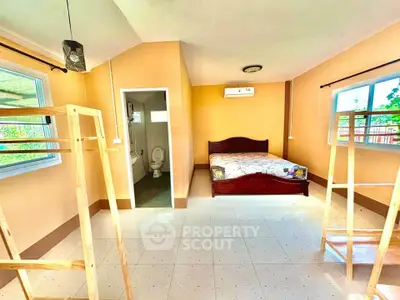 Spacious bedroom with ensuite bathroom and natural light, perfect for comfortable living.