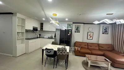 Modern open-plan living room and kitchen with stylish furniture and lighting