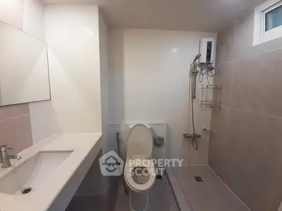 Modern bathroom with sleek fixtures and spacious shower area