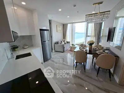 Luxurious open-plan living room with stunning sea view and elegant dining area.