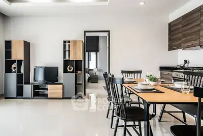 Modern open-plan living and dining area with sleek furniture and stylish decor.