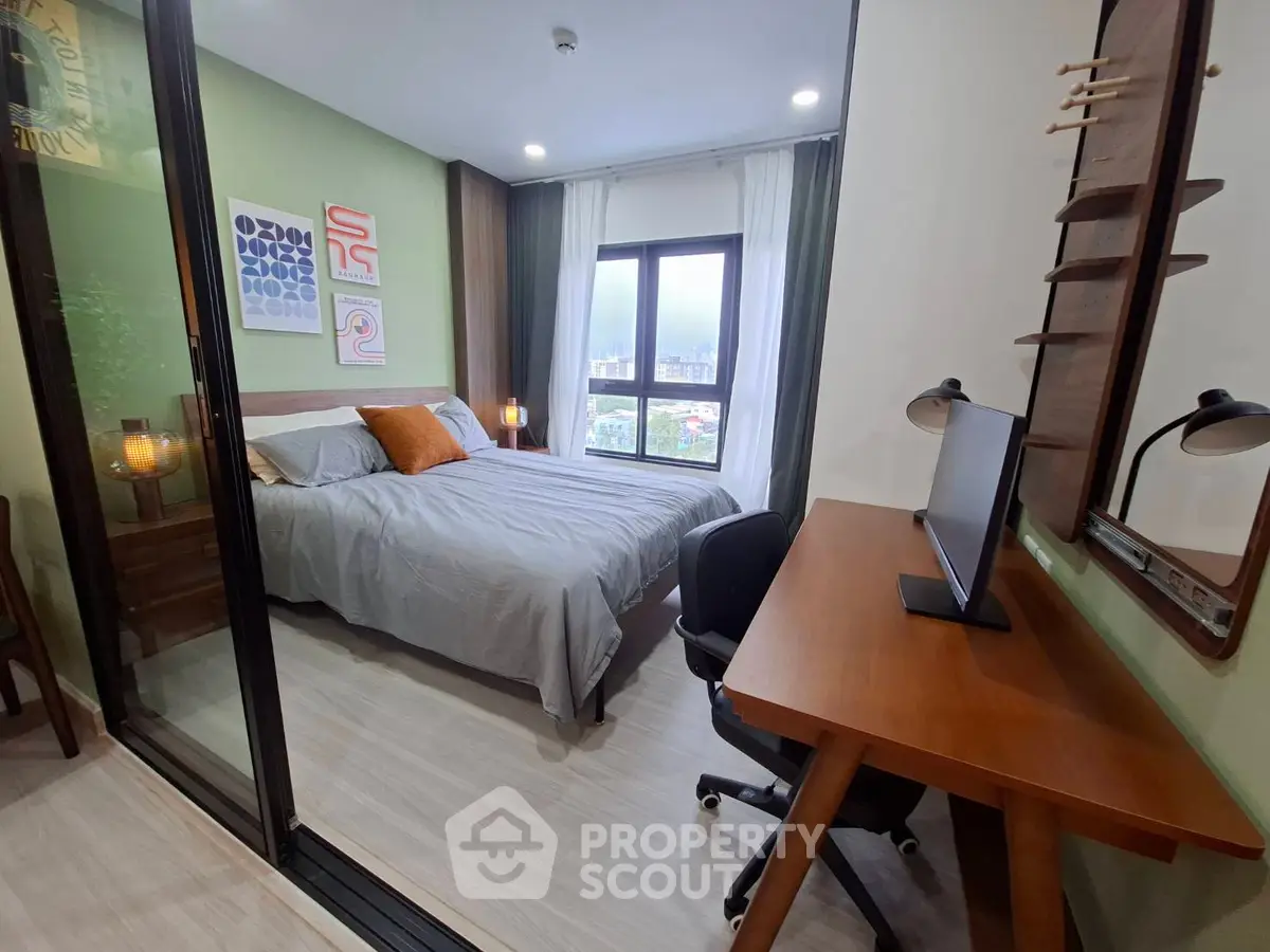 Modern bedroom with study area and large window offering city view