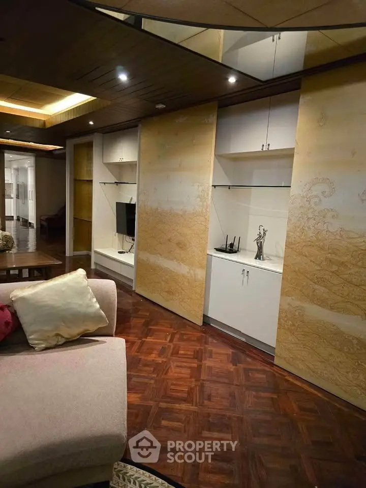 Luxurious living room with elegant wooden flooring and stylish built-in shelves, perfect for modern living.