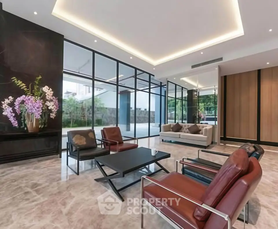 Luxurious modern living room with sleek furniture and floor-to-ceiling windows.