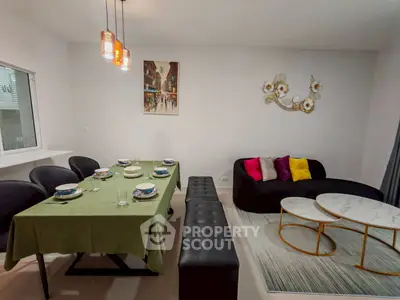 Stylish dining and living area with modern decor and elegant lighting