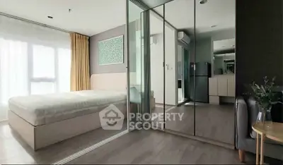 Modern bedroom with mirrored closet and natural light in stylish apartment