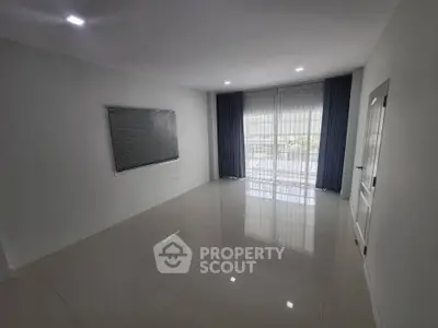 Spacious empty room with glossy tiled floor and large window with curtains, ideal for customization.