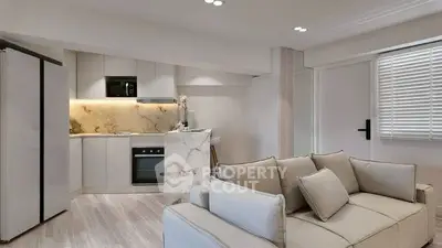 Modern open-plan kitchen and living room with sleek design and neutral tones.