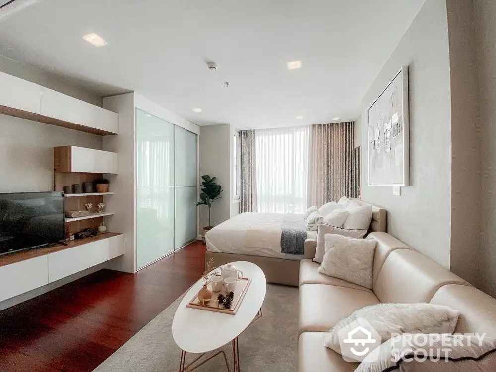 Spacious living room with modern furniture, ample natural light, and a sleek entertainment unit, perfect for urban living.