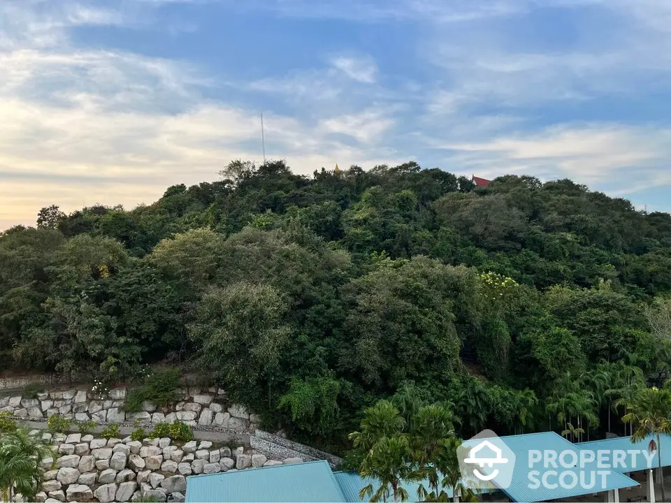 Scenic view of lush greenery and rooftops under a vibrant sky, perfect for nature lovers.