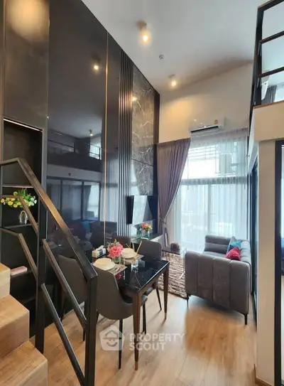 Modern duplex living room with stylish decor and high ceilings