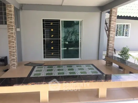 Charming outdoor patio with tiled flooring and modern sliding doors, perfect for relaxation.