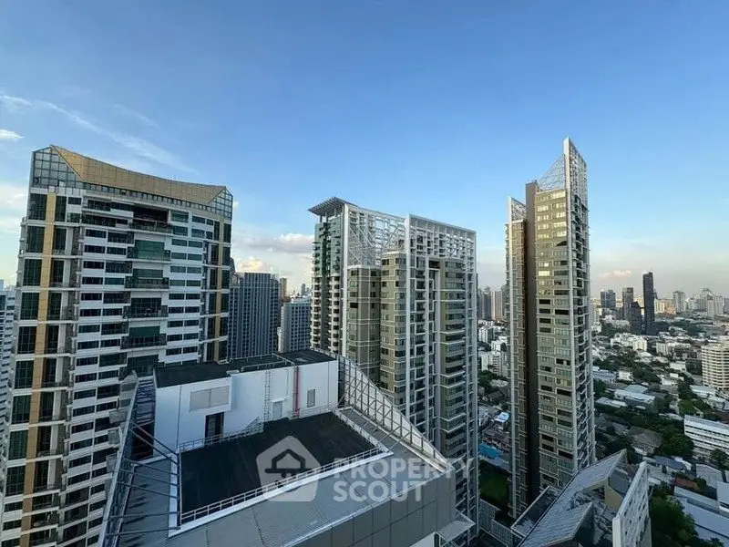 Stunning cityscape view of modern high-rise buildings under a clear blue sky.