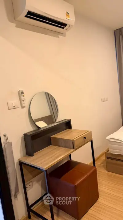 Modern bedroom with air conditioning and stylish wooden furniture, perfect for comfort and relaxation.