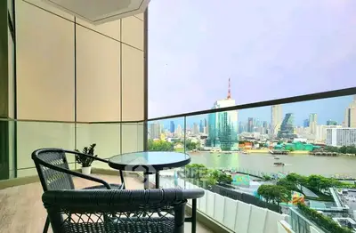Stunning cityscape view from a modern balcony with stylish seating, perfect for relaxation.