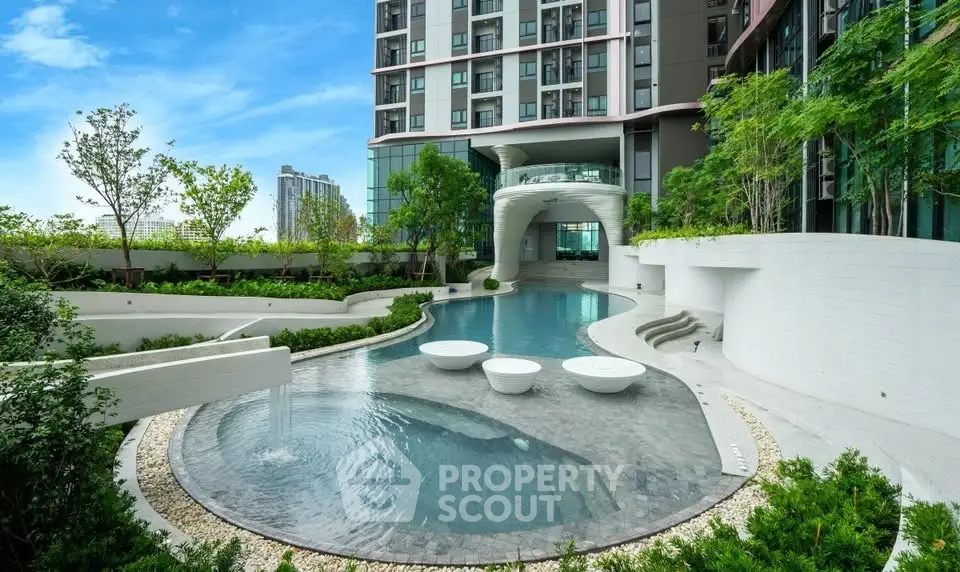 Luxurious modern apartment building with stunning pool and lush greenery