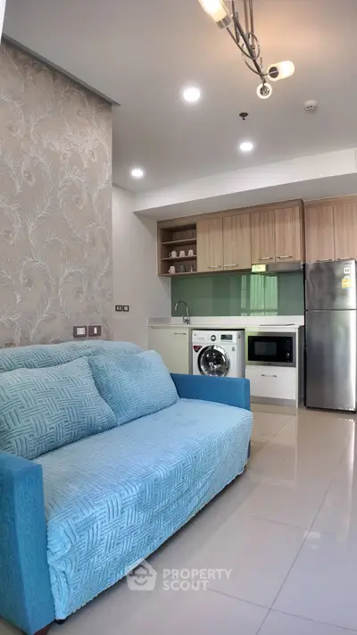 Modern open-layout kitchen with cozy living area and stylish decor