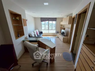 Modern living room with sleek furniture and large window offering city view.