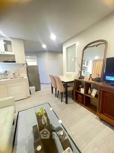 Chic modern living room with open kitchen, elegant dining area, and stylish decor in a cozy apartment.