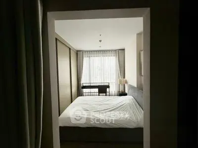 Cozy bedroom with large window and modern furnishings