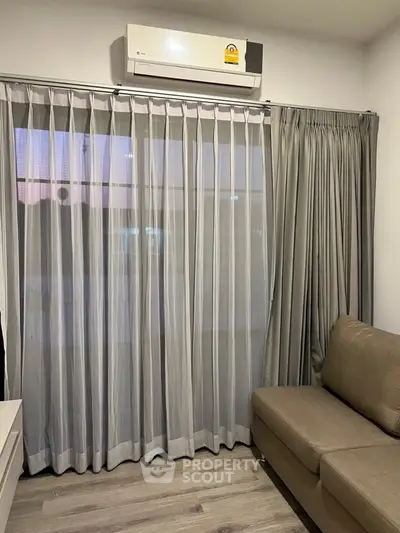 Cozy living room with modern air conditioning and elegant curtains