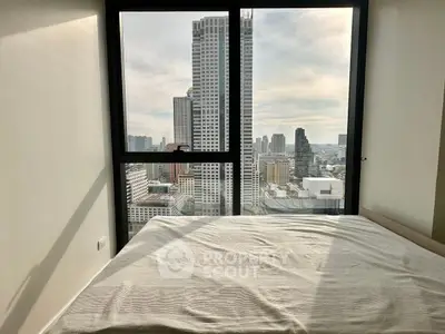 Stunning city view from a modern bedroom with large windows and natural light.