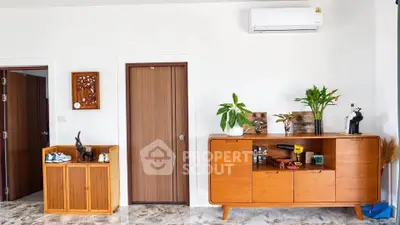 Stylish modern living room with wooden furniture and air conditioning unit.