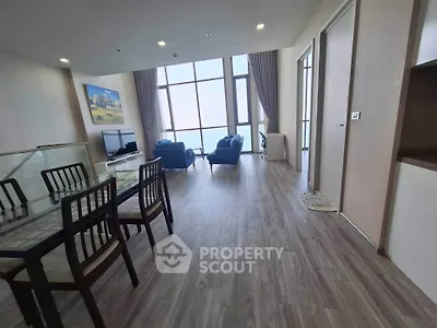 Spacious modern living room with large windows and elegant decor