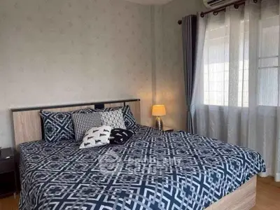 Cozy bedroom with stylish decor and ample natural light