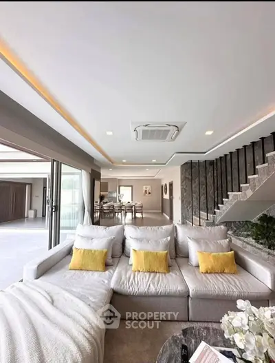 Luxurious open-plan living room with modern decor and spacious seating area.