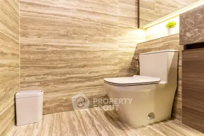 Luxurious modern bathroom with elegant marble tiles and sleek fixtures.