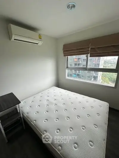 Modern bedroom with air conditioning and large window offering city view