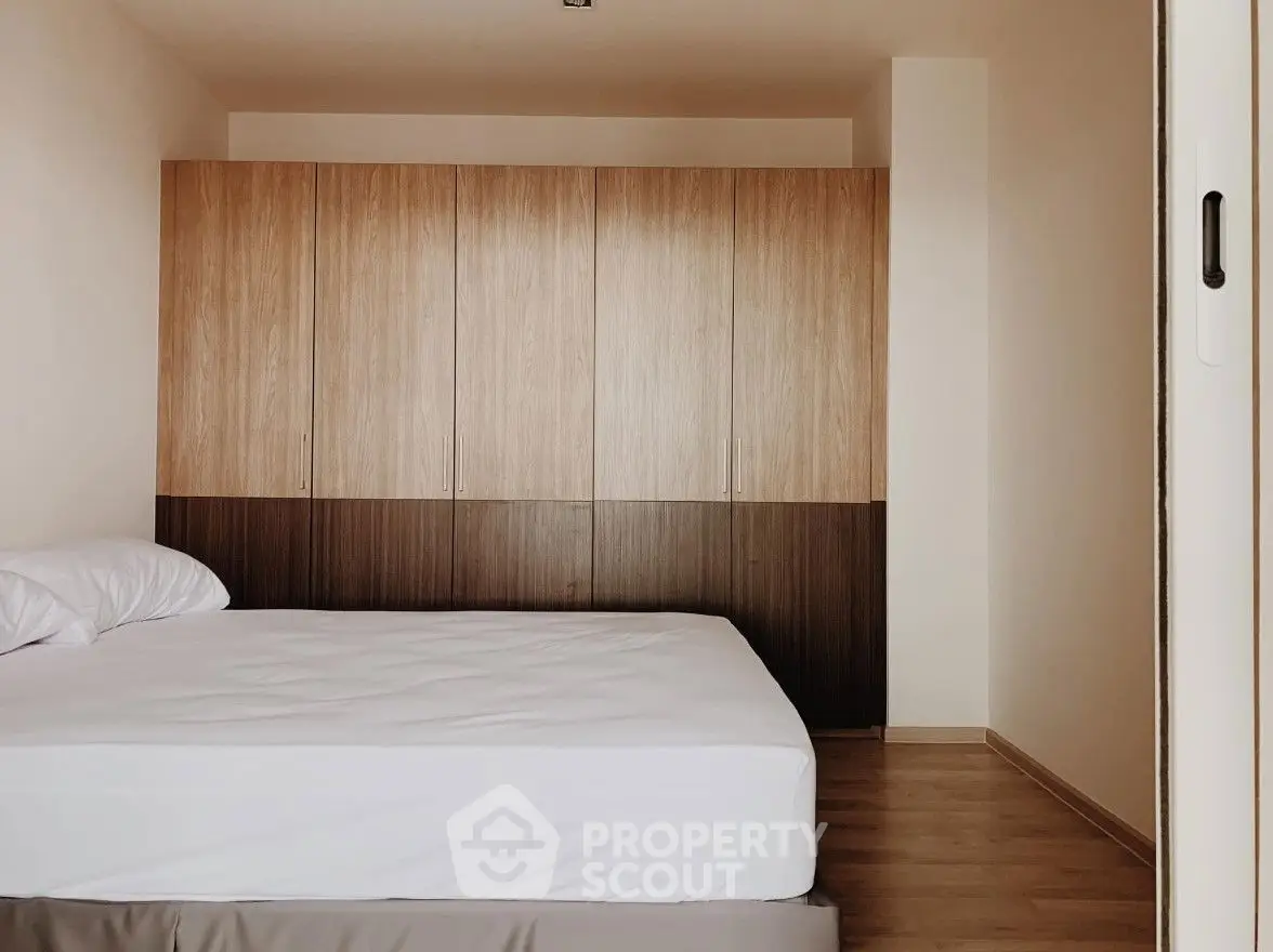 Cozy bedroom with wooden wardrobe and minimalist design