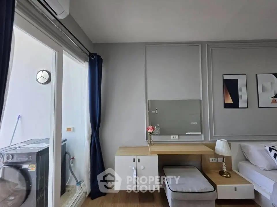 Modern living room with stylish decor and balcony access in a contemporary apartment.