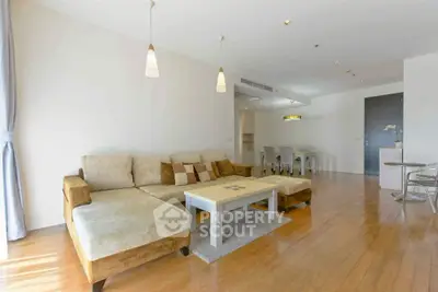 Spacious living room with modern decor and wooden flooring