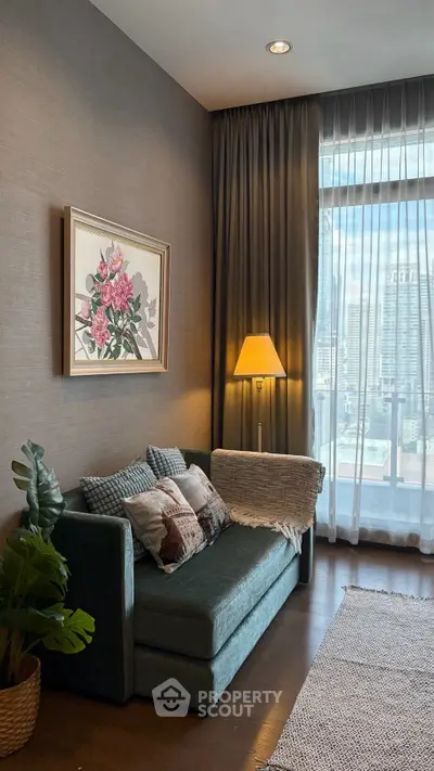 Cozy living room with elegant decor and city view, featuring a plush sofa and stylish lighting.
