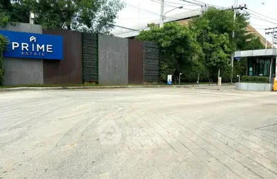 Prime Estate entrance with modern design and lush greenery, showcasing a welcoming and secure environment.