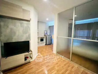 Modern living room with wooden flooring and sliding glass partition