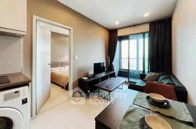 Modern living room with open layout, cozy seating, and natural light from large windows.