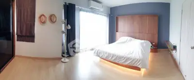 Spacious modern bedroom with natural light and stylish decor