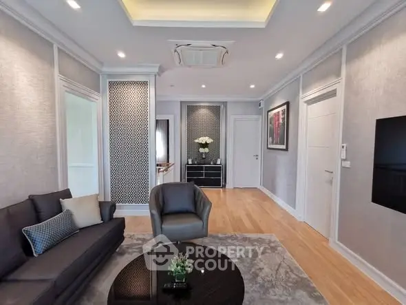 Elegant living room with modern decor and stylish furniture, featuring a cozy seating area and sophisticated wall design.