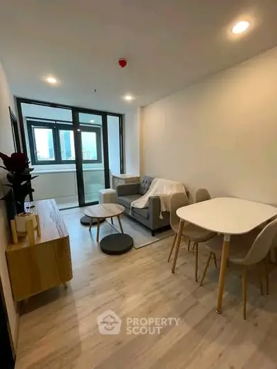 Modern living room with stylish furniture and large windows in a contemporary apartment.